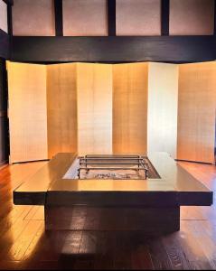 a kitchen with a stove in the middle of a room at The Ninja Mansion in Toyota