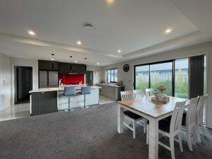 a kitchen and dining room with a table and chairs at Luxury 4 Bedroom Family Retreat in Lincoln