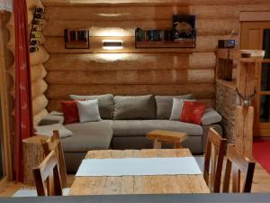 a living room with a couch and a table at Ferienhaus - Chalet - Lechtraum in Stanzach