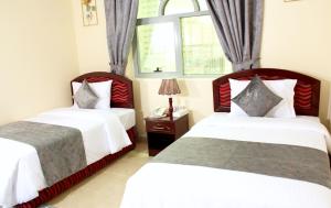 Postel nebo postele na pokoji v ubytování Al BARAKAH HOTEL