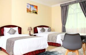 Postel nebo postele na pokoji v ubytování Al BARAKAH HOTEL