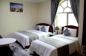 Postel nebo postele na pokoji v ubytování Al BARAKAH HOTEL