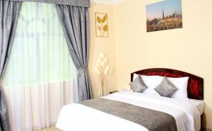 Postel nebo postele na pokoji v ubytování Al BARAKAH HOTEL