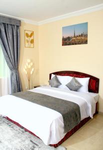 Postel nebo postele na pokoji v ubytování Al BARAKAH HOTEL