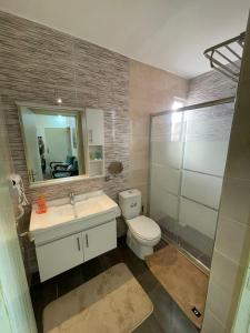 a bathroom with a toilet and a sink and a mirror at Classy Guesthouse in Madaba +45 photos