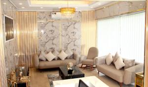 a living room with two couches and a table at Al BARAKAH HOTEL in Sharjah