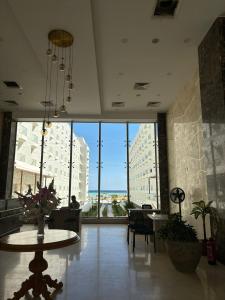 a large room with tables and chairs and a large window at Scandic Resort, free WiFi, sandy beach, coral reef in Hurghada
