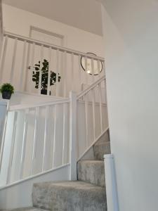 a staircase with white railings and a potted plant at Supreme Room in Thornaby on Tees