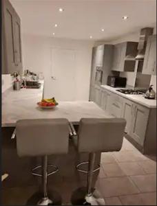 a kitchen with two chairs and a counter in it at Supreme Room in Thornaby on Tees