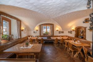 a dining room with wooden tables and chairs at Gasthof Löwen in Schruns-Tschagguns