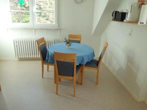 einen Esstisch mit einem blauen Tischtuch und Stühlen in der Unterkunft Ferienwohnung Burgenblick in Cochem