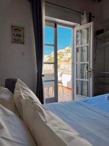 a bedroom with a bed and a sliding glass door at in Hydra in Hydra