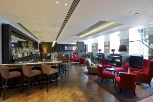 a restaurant with tables and chairs in it at London Bridge Hotel in London