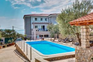 an image of a villa with a swimming pool at Apartments Alberta in Miholašćica
