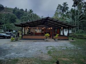 a house with a black roof at Miridiya Resort in Yatiyantota