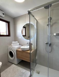 a bathroom with a washing machine and a washer at Apartments Flora 1 in Rab