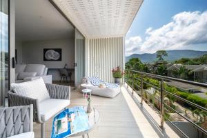 a balcony with a view of the mountains at Sea&Sky Beach Resort Beachfront Bungalows & Pool Villas in Mae Nam