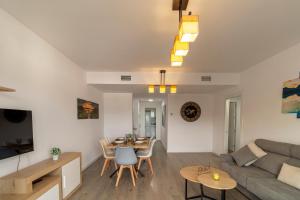 a living room with a couch and a table at RentitSpain - Playa Granada - Apartamento Aguacate Golf y Costa in Motril