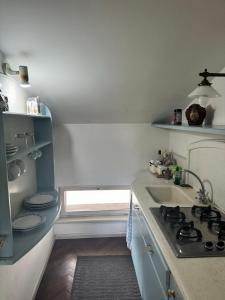 Una pequeña cocina con fregadero y estufa. en Heart of Parma - Air Conditioning con posto auto prenotabile, en Parma 8 fotos más
