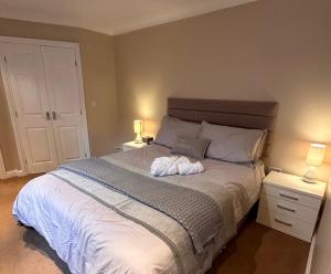 a bedroom with a bed with two night stands and two lamps at Max's Woodland Lodge in Bridlington