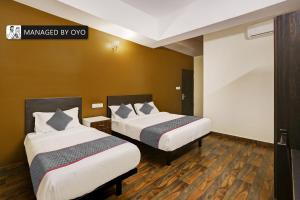 a hotel room with two beds in a room at Super Collection O Singasandra Hosa Road in Bangalore