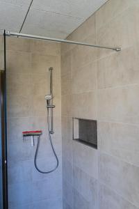 a shower with a shower head in a bathroom at Ferienwohnung Am Rhaunelbach in Rhaunen