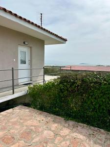 a house with a balcony with a view of the ocean at Village escape: στην Πρέβεζα in Flámpoura
