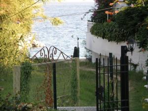 a wrought iron fence next to a body of water at Vontzos Hotel in Achladies