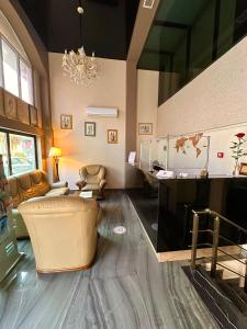 a large living room with a couch and a chandelier at Hotel Aristocrat Batumi in Batumi