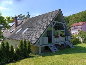 a house with a gambrel roof with a porch at Dom Marek in Wisełka