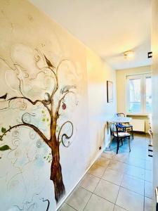 a wall with a painting of a tree on it at Apartament Kameralny nad Motławą in Gdańsk