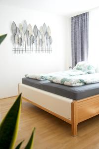 a bedroom with a bed with a wooden bed frame at Modern Danube Apartment Vienna in Vienna