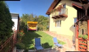 a yard with two chairs and a gazebo at Casa Matei in Turda