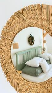 a large wicker mirror over a bed in a bedroom at Sebuzínka in Ústí nad Labem