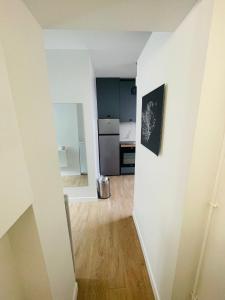an empty room with a kitchen and a hallway at Studio Parc des Princes - Porte dauphine - 2 Pers in Boulogne-Billancourt