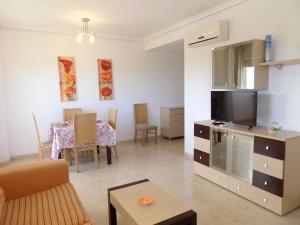 a living room with a television and a dining room at Playa R84MED010 in La Estación