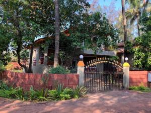 a gate in front of a house with trees at Dev Villa Dapoli in Dapoli