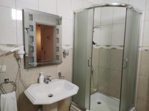 a bathroom with a sink and a shower at Hotel & Restaurant White City in Berat +37 photos
