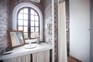a bathroom with a sink and a window and a mirror at AROMA HOUSE - Private entire house on Cat Ba island in Cat Ba +44 photos