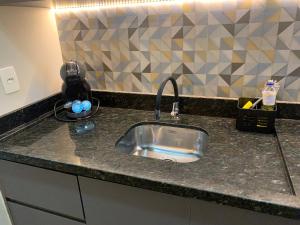 a kitchen counter with a stainless steel sink at Get a Flat 1009 Luxuoso - Bienal in Sao Paulo