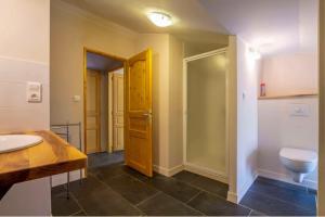 a bathroom with a toilet and a sink at Mas Chantequinson in Les Assions