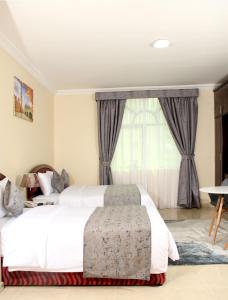 Postel nebo postele na pokoji v ubytování Al BARAKAH HOTEL