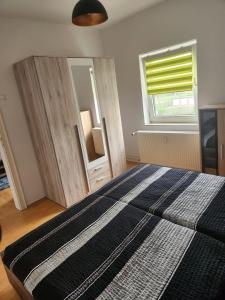 um quarto com uma cama, uma janela e um espelho em Wohnung HAMMer em Hamm