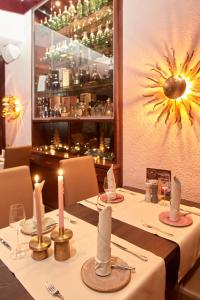 a table in a restaurant with candles on it at Hotel Restaurant Doppeladler in Rees