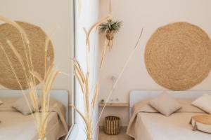 a white bedroom with a bed and a mirror at Casa Calida - 500m to Kos Town in Kaká Pinári