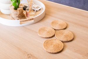 a wooden table with four wood disks on it at Casa Calida - 500m to Kos Town in Kaká Pinári