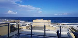 a view of the ocean from the balcony of a building at Sunseaker- Beachfront Complex in Ballito