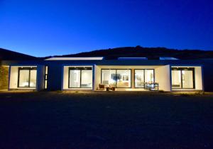 a house at night with the lights on at Dream Cave Villa Tinos in Tinos Town