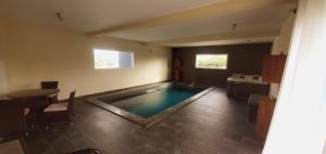 a kitchen with a pool in the middle of a room at Le Margaret Holidays in La Plaine des Cafres
