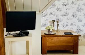 a television sitting on a table in a room at 't Heerenhuys in Wageningen